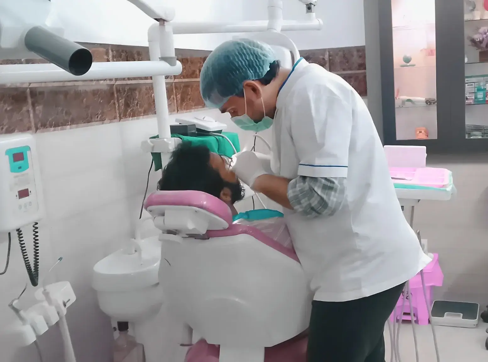 Dr. Raza Abbas Zaidi, Dentist & Dental Surgeon, treating a patient at Hadi Perfect Smile Dental Clinic.